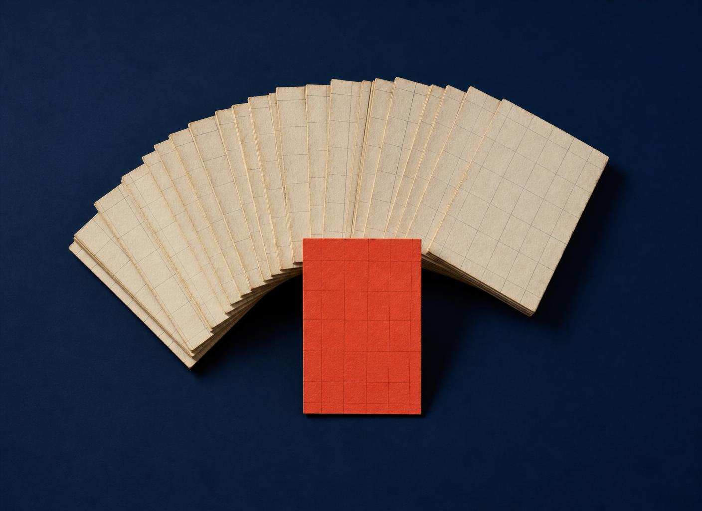 Paper-craft fan of cream index cards with one coral card standing forward